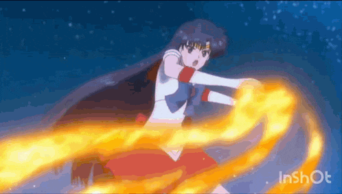 a girl in a red dress is holding a fireball in her hand .