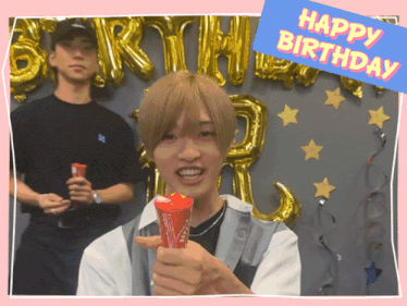 a man holding a red cone with the words happy birthday behind him