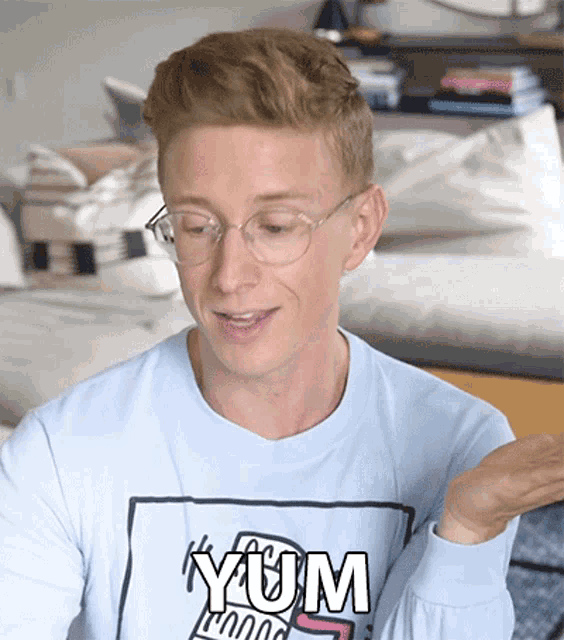 a young man wearing glasses and a shirt that says yum on it