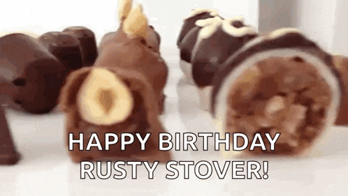 a bunch of chocolate candies are sitting on a table with the words `` happy birthday rusty stover '' written on them .