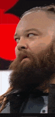 a man with a beard and dreadlocks is looking to the side