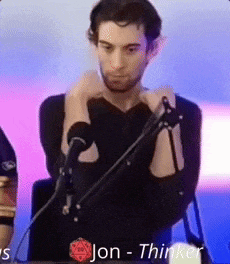 a man in a black shirt is standing in front of a microphone with the name jon - thinker on the bottom