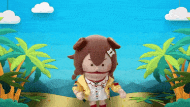 a stuffed animal is standing on a beach with palm trees and mountains in the background .