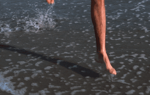 a man in red shorts carrying a red life preserver