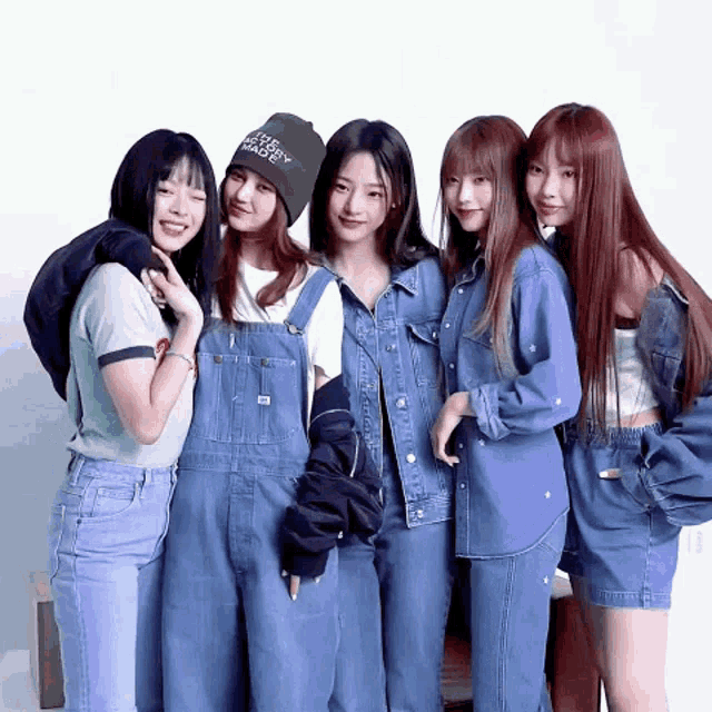 a group of young women are posing for a picture and one of them is wearing a beanie that says i love you