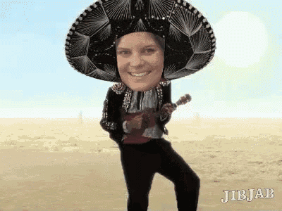 a person wearing a sombrero and holding an ukulele .