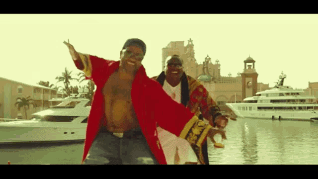 a man in a red robe is dancing with another man in a gold robe