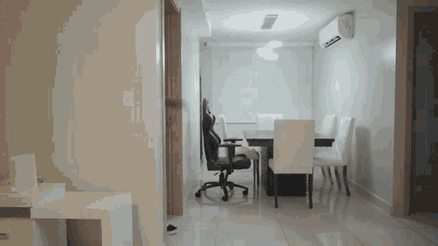 a dining room with a table and chairs and a black chair