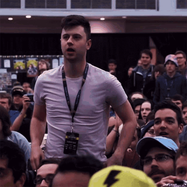 a man with a lanyard around his neck has a ticket that says " third day " on it