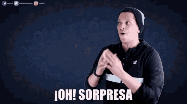 a man with a surprised look on his face is wearing a black adidas jacket