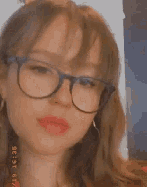 a close up of a woman wearing glasses .