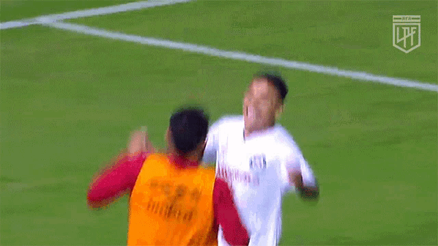a soccer player wearing a jersey that says ' umbro ' on the back