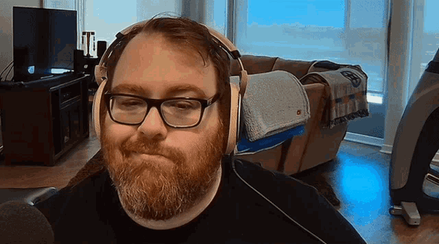 a man with a beard wearing headphones and glasses