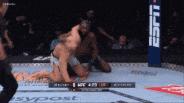 two men in a boxing ring with a espn banner on the side