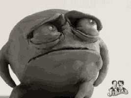 a clay sculpture of a frog with a sad look on his face .