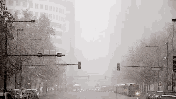 a snowy city street with a sign that says ' smith ' on it