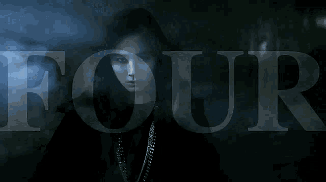 a woman in a dark room with the word four in the background