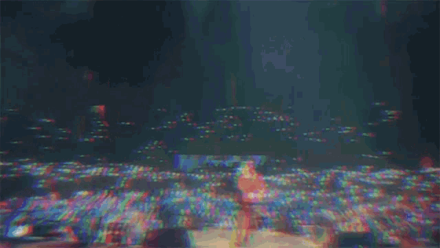 a blurry image of a person playing a guitar