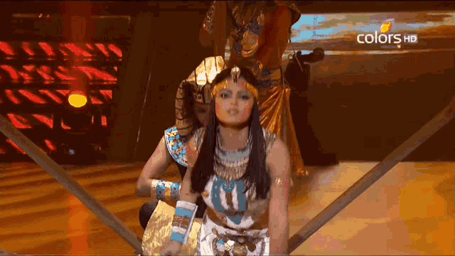 a woman in a costume is on a television screen that says colors hd on it