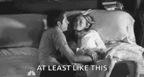 a man and a woman are laying on a bed .