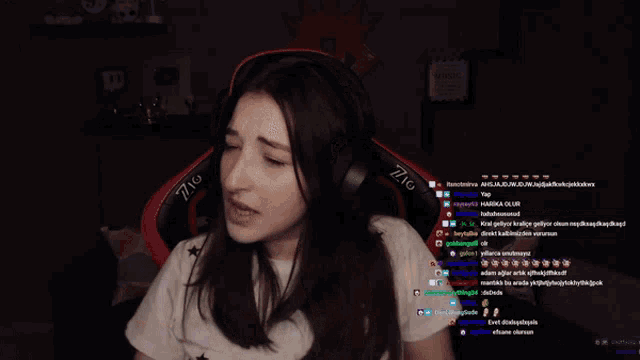 a woman wearing headphones and a shirt that says 771 on it