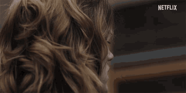 a close up of a woman 's face with the word netflix behind her