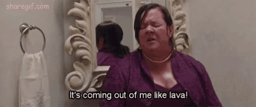 a woman in a purple dress is standing in front of a mirror and saying `` it 's coming out of me like lava ''