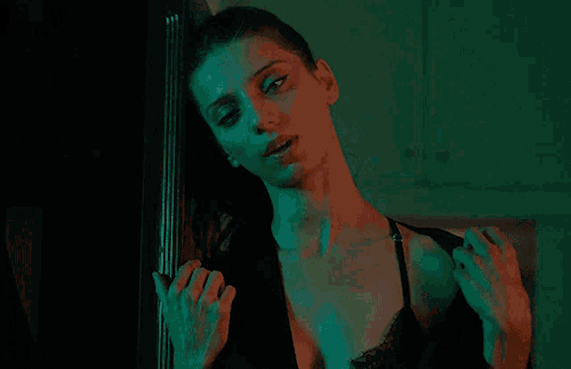 a woman in lingerie is standing in front of a refrigerator