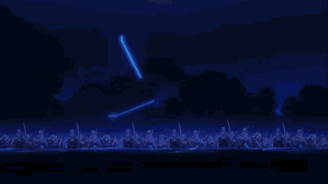a group of people are standing in a dark room with a blue light coming out of a person 's hand