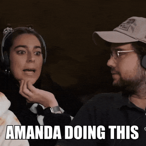 a woman wearing headphones talks to a man wearing a hat with the words " amanda doing this " on it
