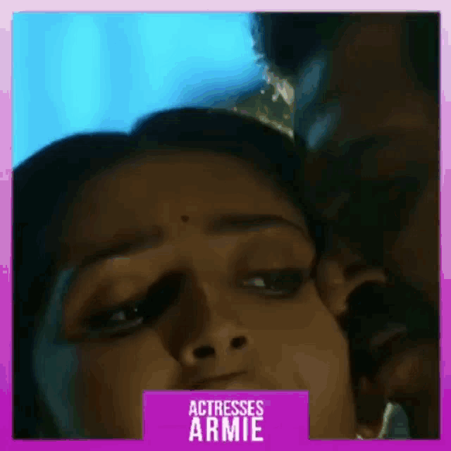 a man is kissing a woman on the cheek in a close up of their faces .