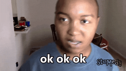 a person with a blue shirt that says ok ok ok on it