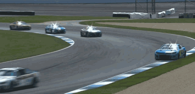 a race car is going around a curve with smoke coming out of it