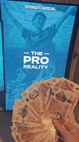 a person is holding a bunch of money in front of a poster that says the pro reality