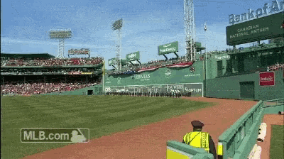 a mlb.com advertisement shows a baseball stadium with a green wall