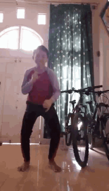 a person is dancing in front of a bicycle