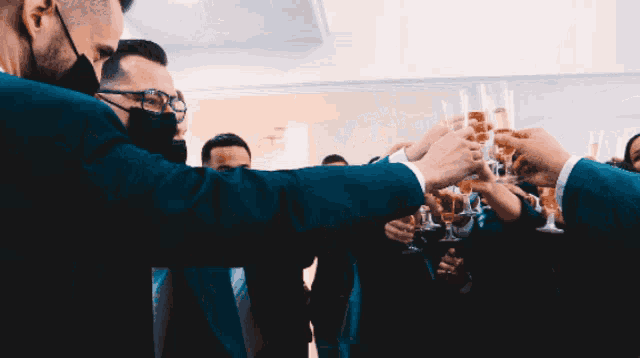 a group of people toasting with champagne glasses in their hands