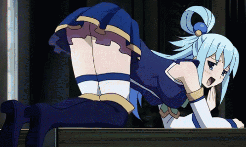 a girl in a blue skirt is laying on her stomach on a table .