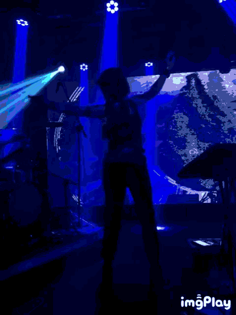 a silhouette of a person in a dark room with the words imgplay below