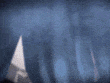 a blurred image of a person in a white hat