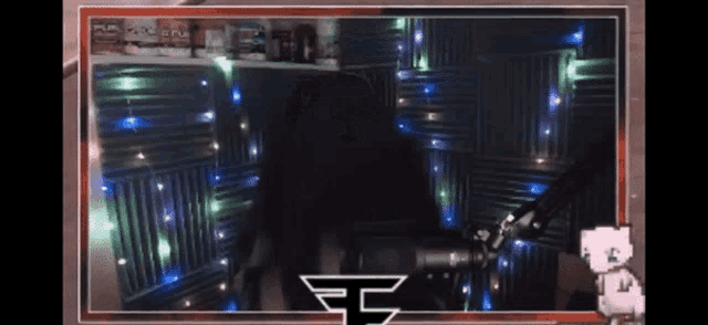a picture of a person sitting in front of a microphone with the letter f on the bottom right