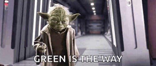 yoda is pointing at the camera and saying `` green is the way '' while standing in a hallway .