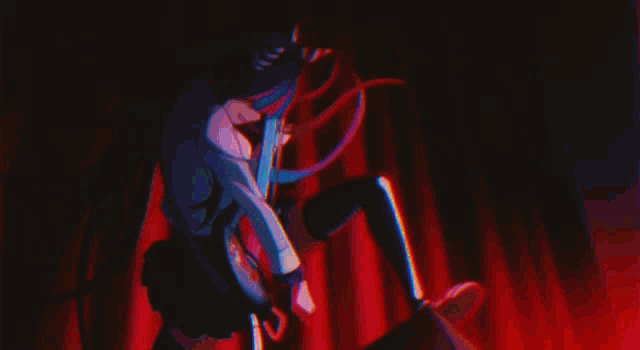 a person is holding a torch in a dark room with a red curtain in the background .