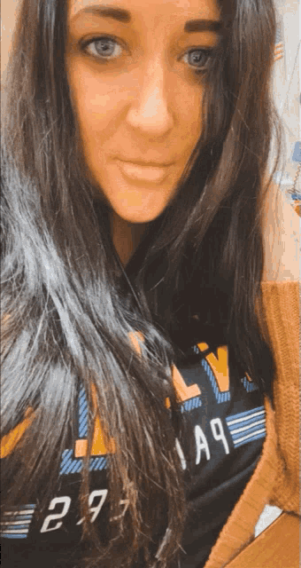 a woman taking a selfie with a shirt that has the number 29 on it