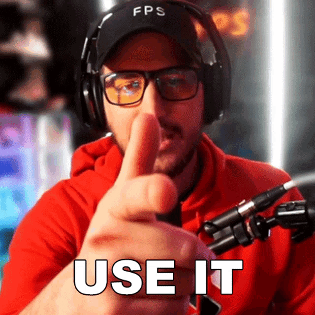 a man wearing headphones and glasses is pointing at the camera with the words use it written below him
