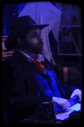 a man in a cowboy hat says get outta here tear while playing a video game
