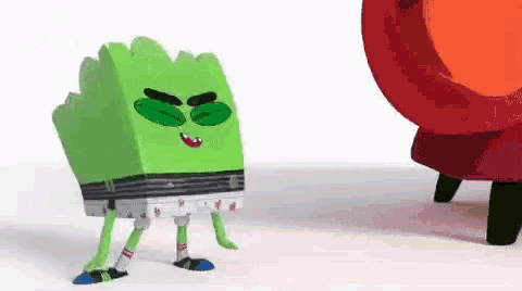 a green cartoon character with green eyes and legs is standing next to a red object .