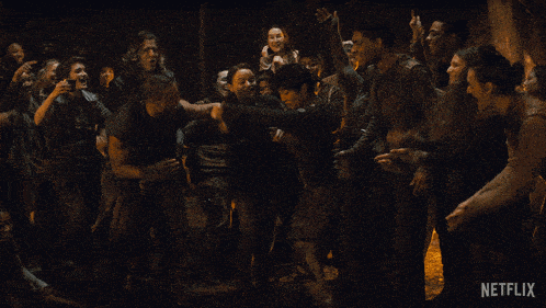 a group of people dancing in a dark room with a netflix logo in the corner