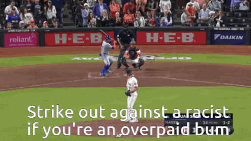 a baseball game being played in front of a h-e-b banner