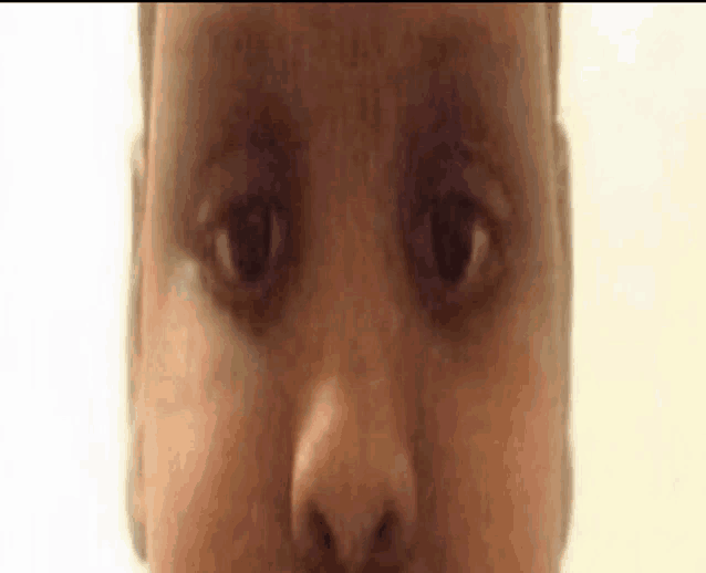 a close up of a baby 's face with a very strange look on it .